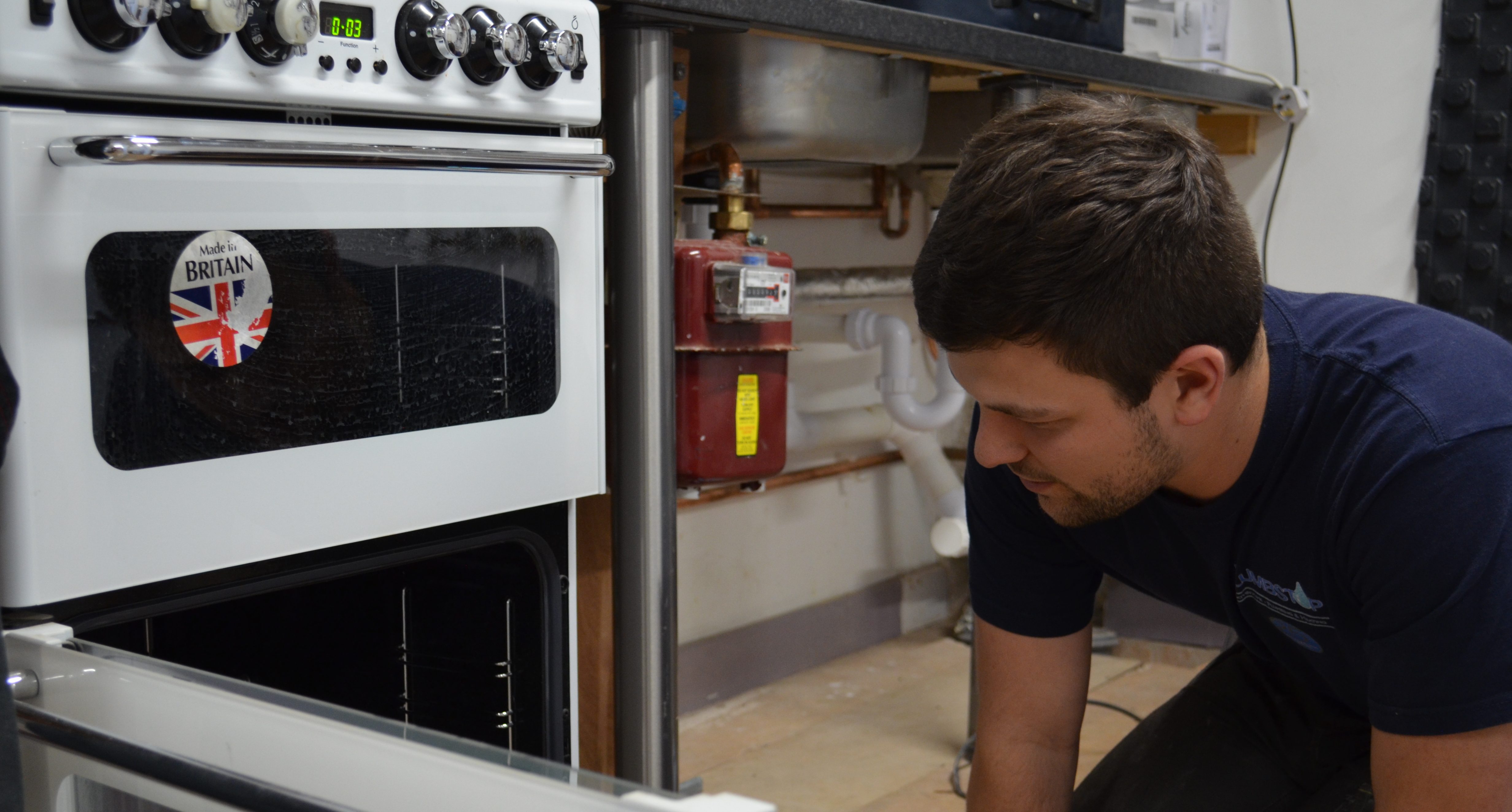Student looking at gas cooker as part of his CKR1 Gas Cookers Re-assessment course.