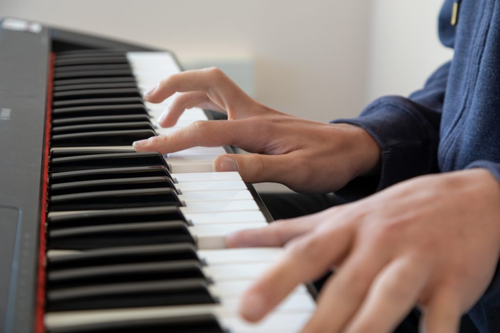 Music student playing the keyboard.