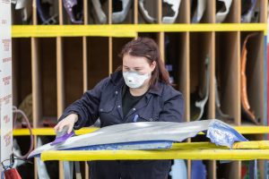 Vehicle body repair student working on her project.