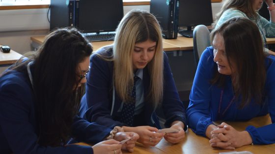 Two students and a memeber of staff working on a task at Women in Engineering Day 2019.
