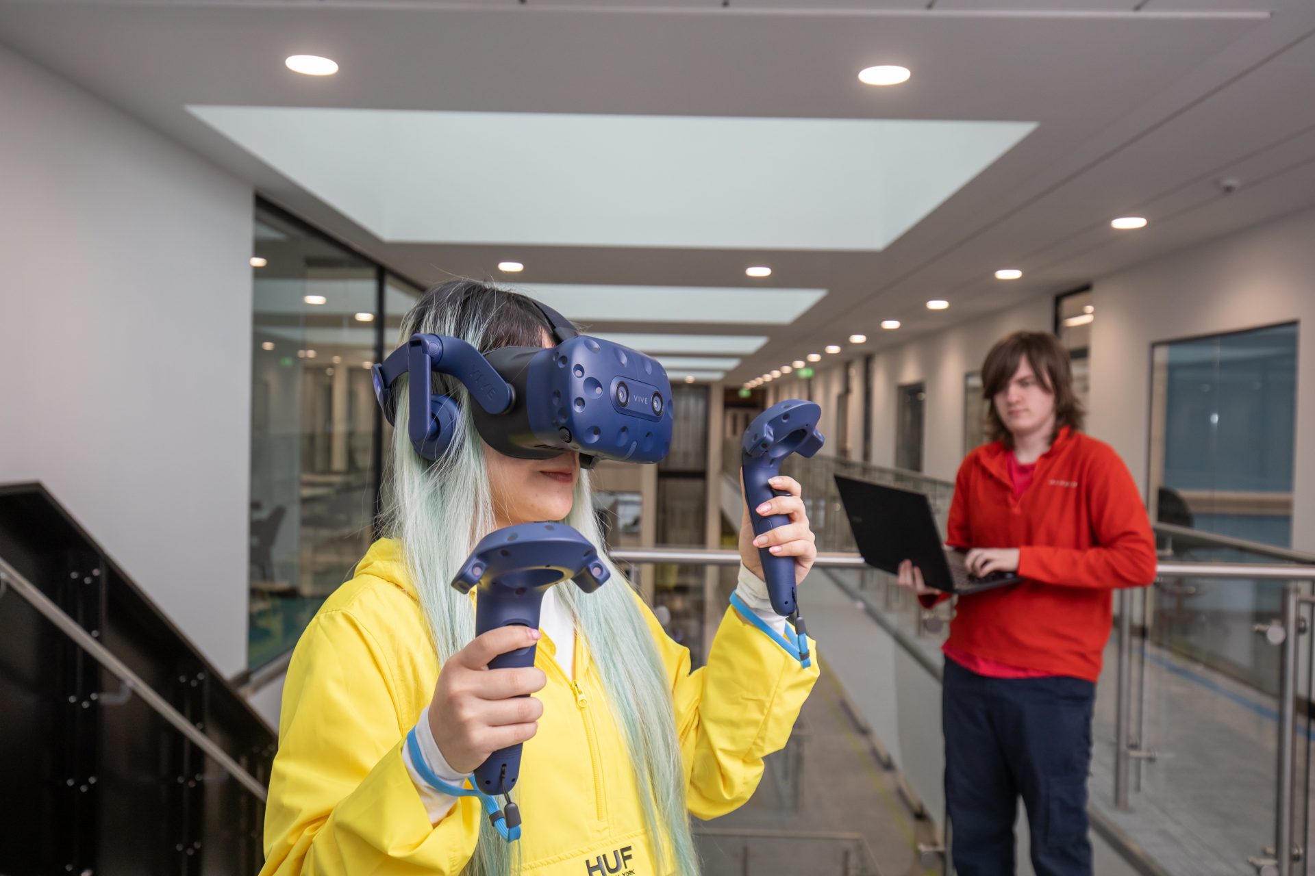 Students using laptops and a VR headset