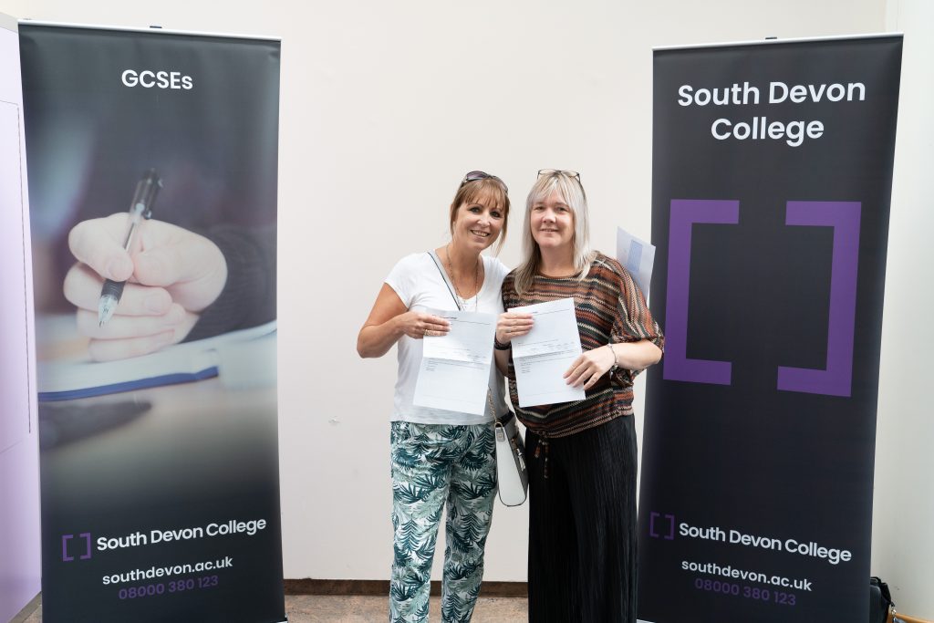 Paula Hough and Lisa Berresford holding their GCSE results