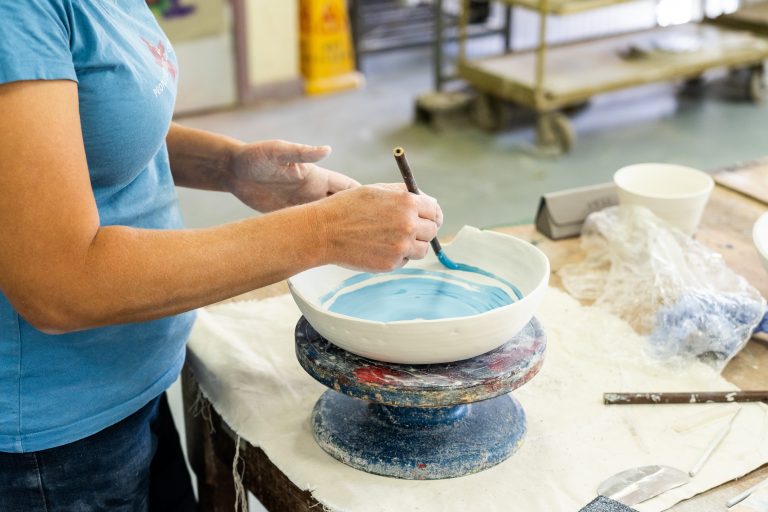 Woman painting a ceramic bowl