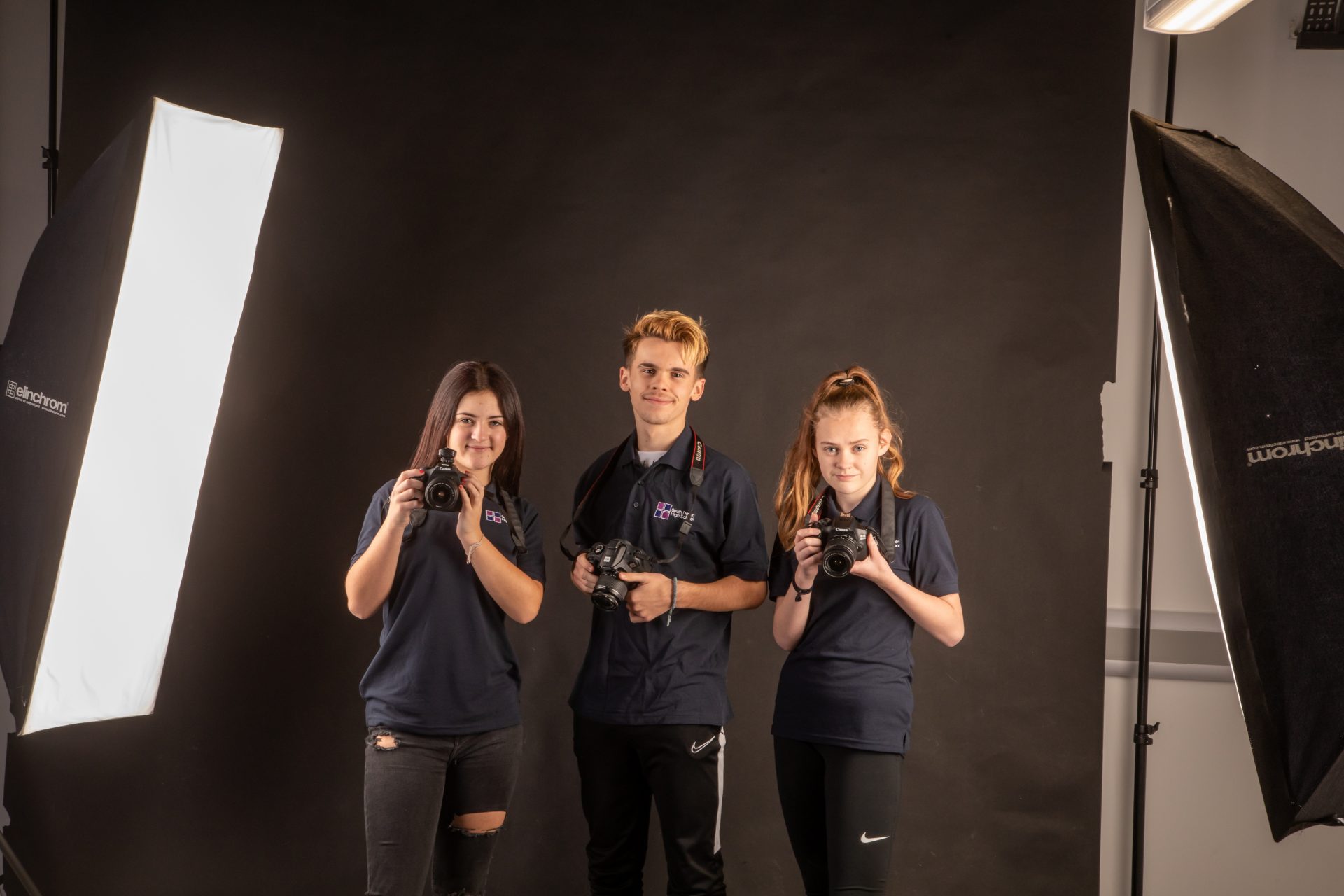 3 South Devon High School photography students holding cameras
