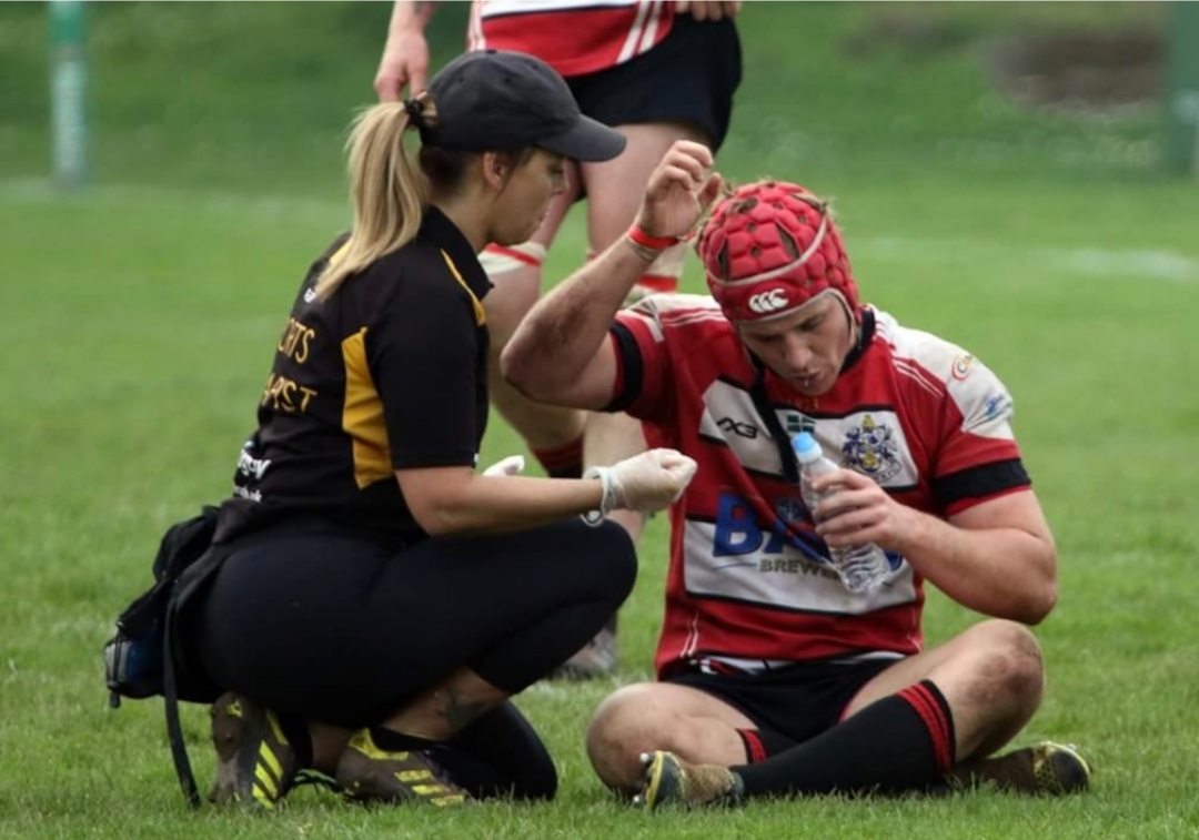 Kerry Mitchell sports therapist helping rugby player