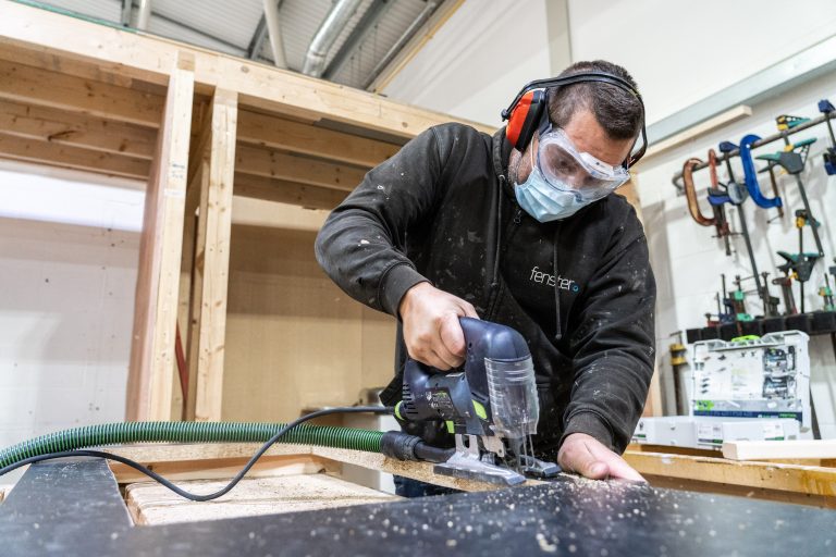 Adult doing carpentry using a jigsaw