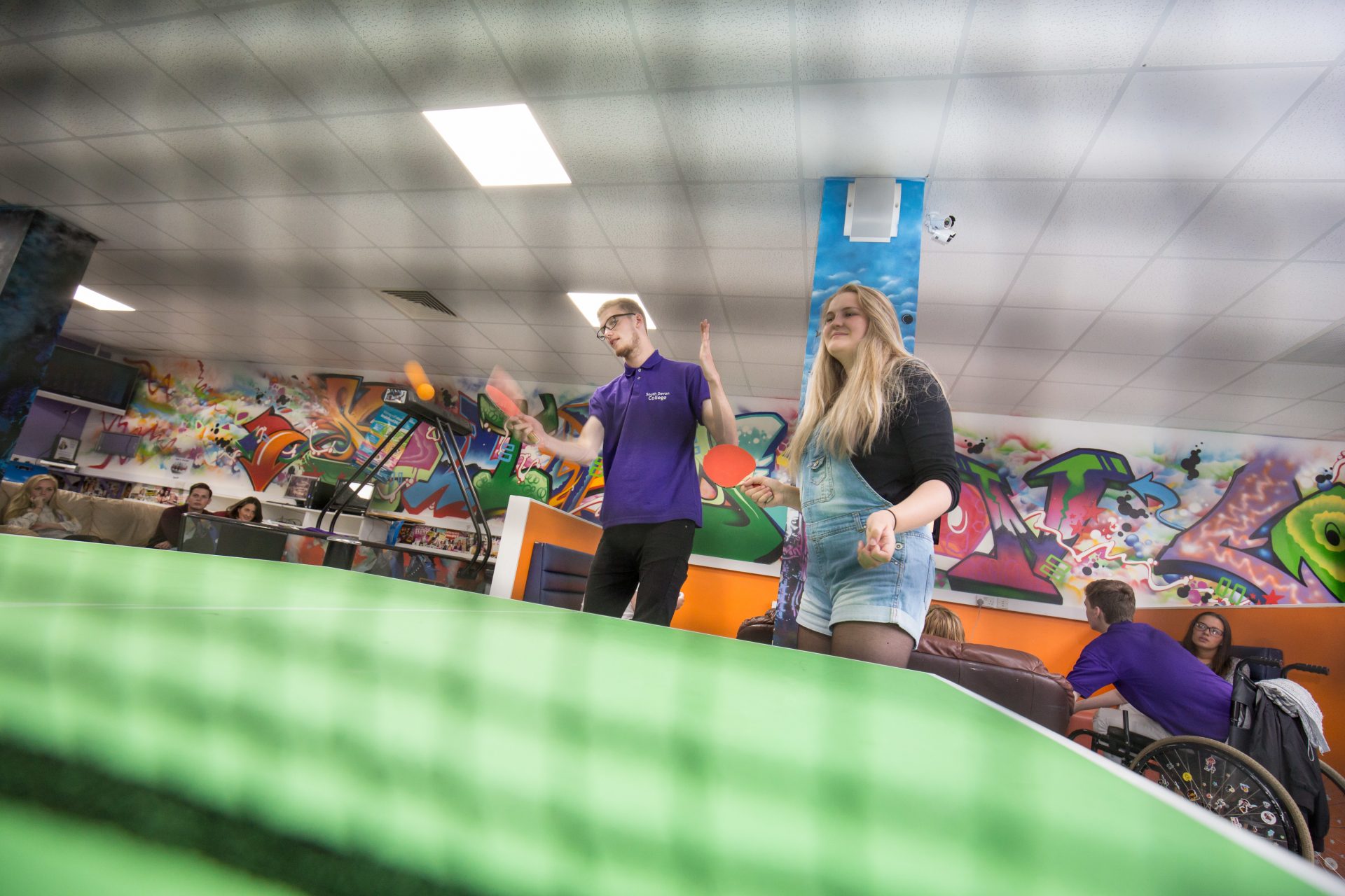 Students playing table tennis in the student union common room