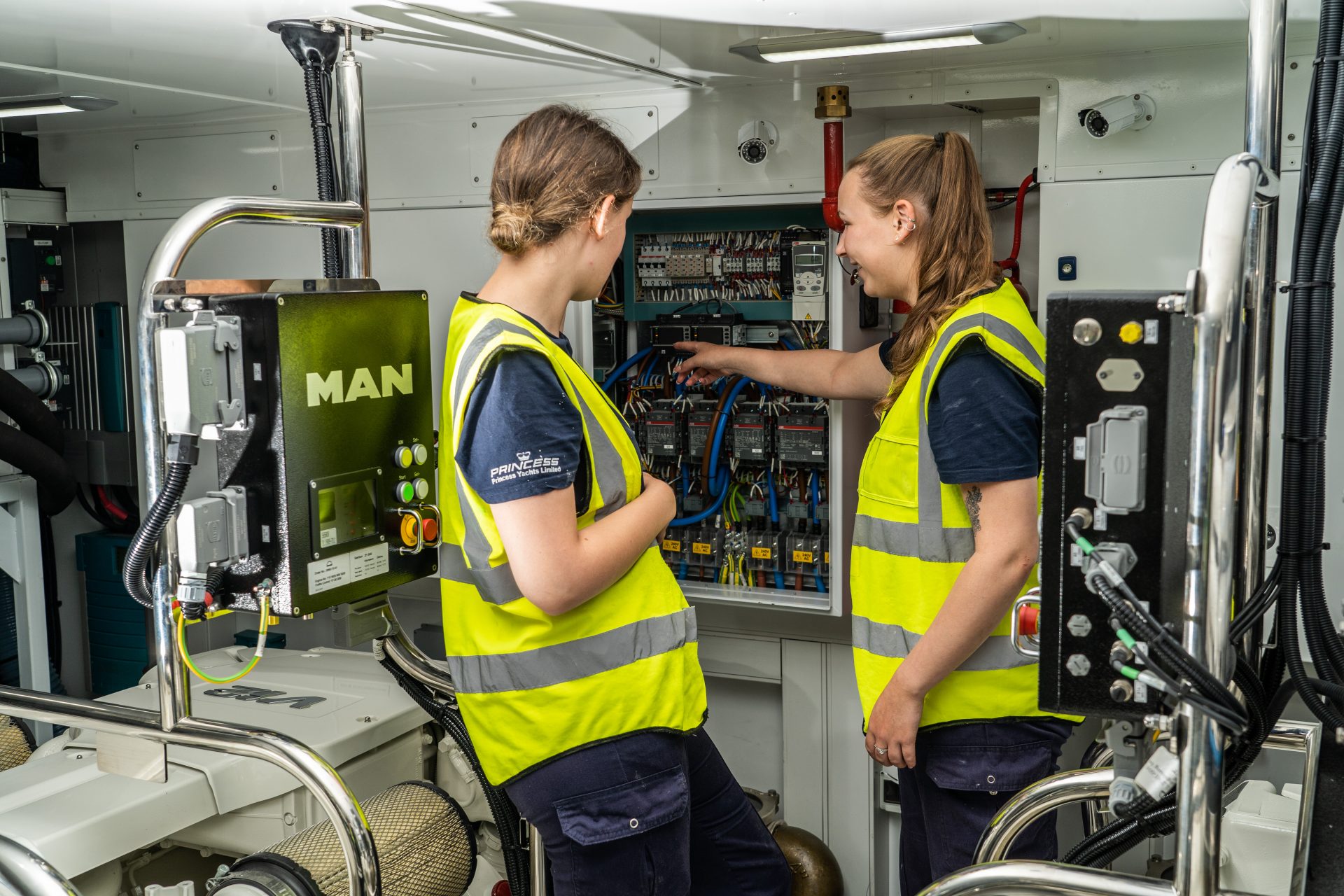 Two Princess Yachts apprentices working in boat engine room