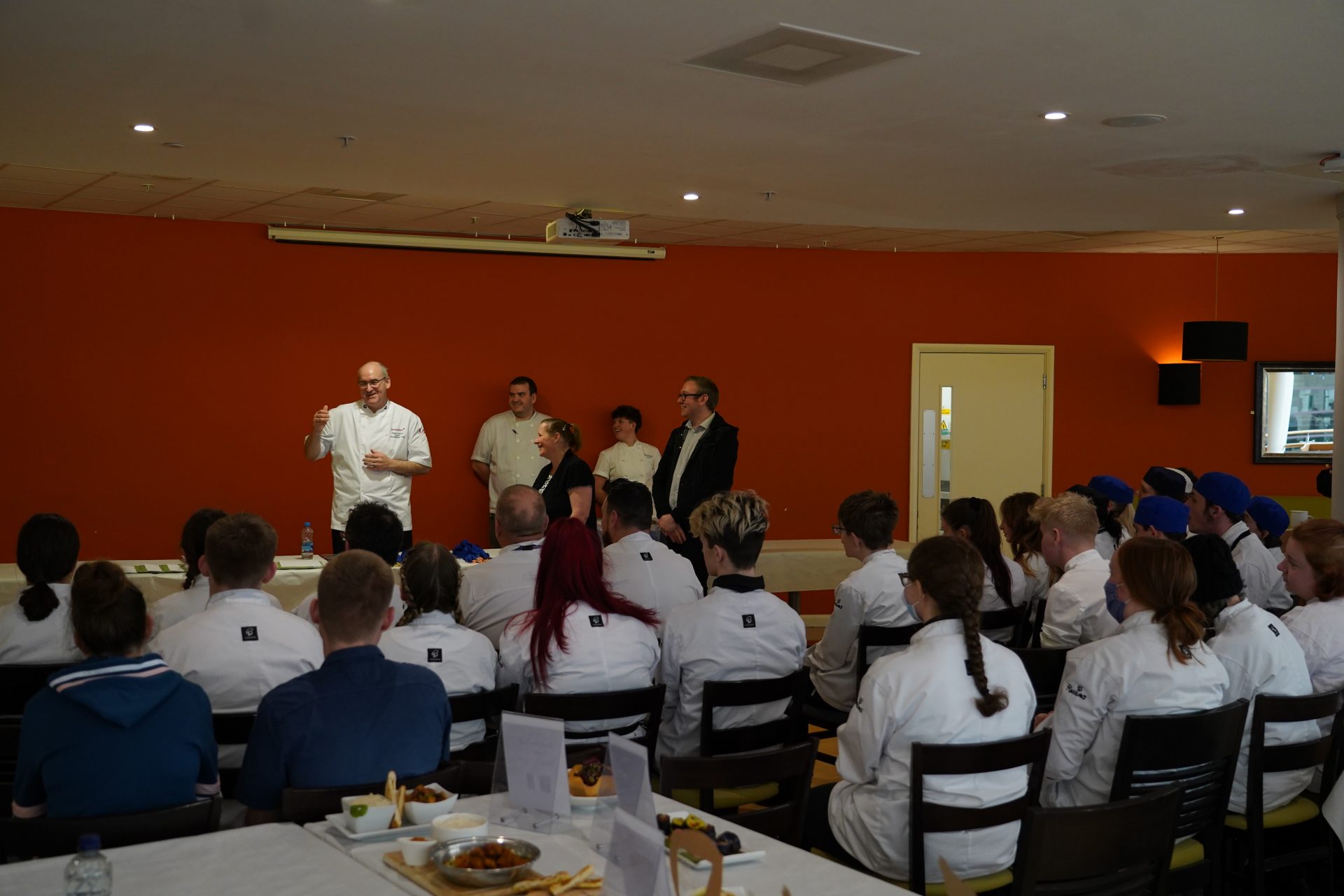 Man conducting award ceremony at Major Series 2022 chef competition 