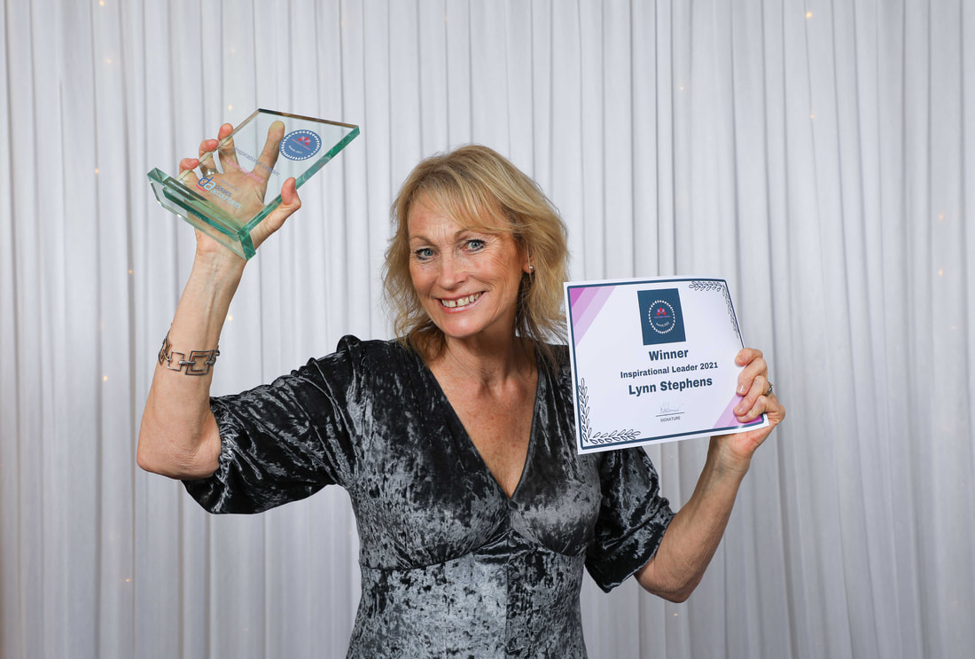 Lynn Stephens celebrating winning award for Inspirational Leader at Devon Women in Business awards