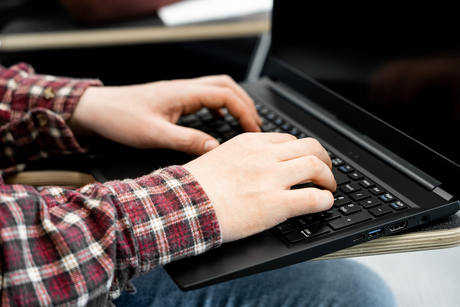 Adult students typing on a laptop