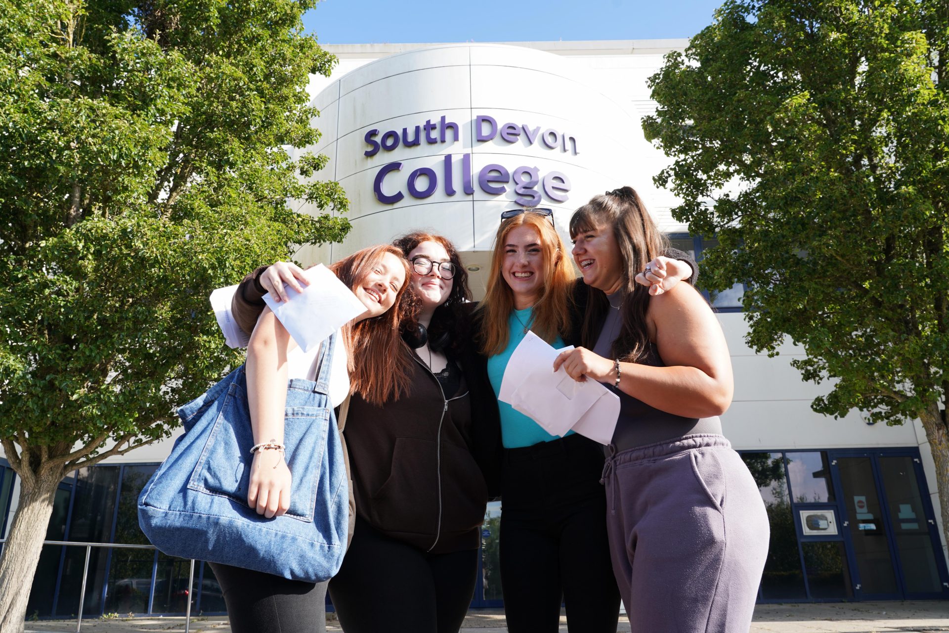 Group of students celebrating on results day outside South Devon College