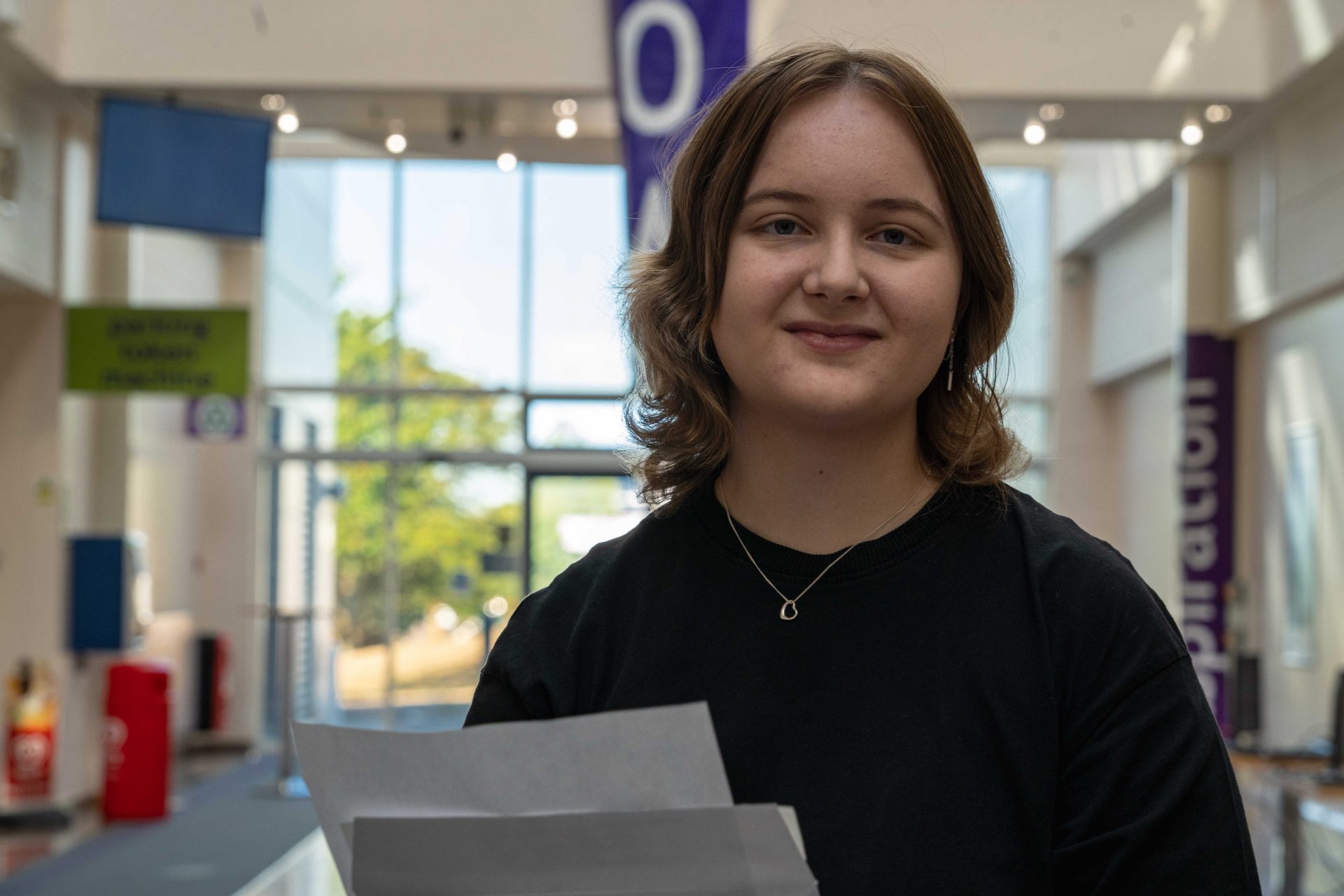 Louise Mason celebrating on results day inside South Devon College