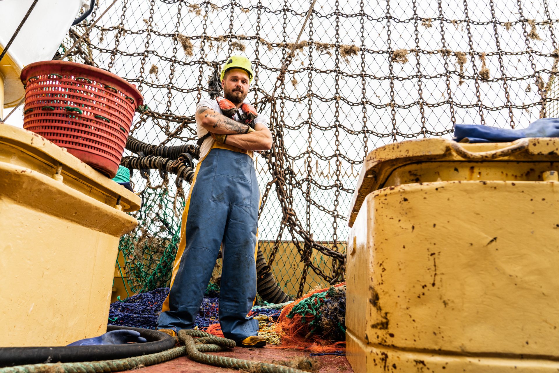 Fisherman standing on deck of a vessel at sea